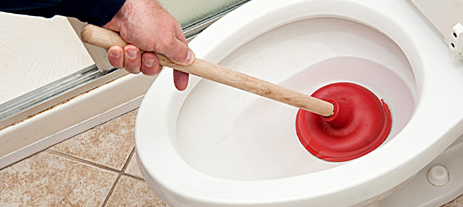 plunging a clogged toilet